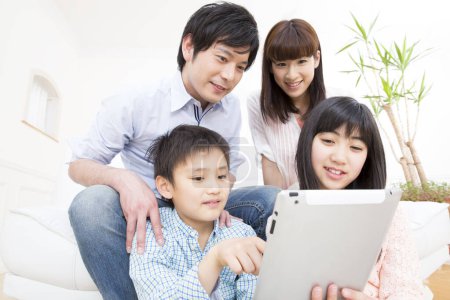 Photo for Family using a tablet at home - Royalty Free Image