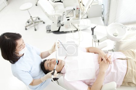 Photo for Asian woman dentist with patient  in dental office - Royalty Free Image