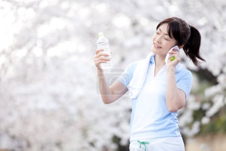 Photo for Close up beautiful mature asian woman drinking water - Royalty Free Image