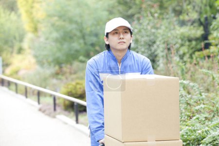 Photo for Delivery young man with boxes - Royalty Free Image