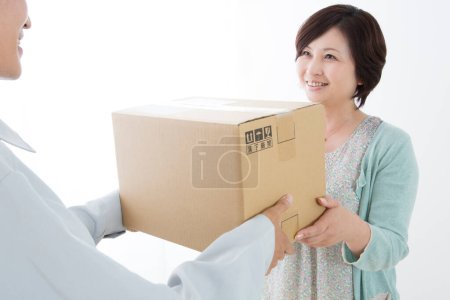 Photo for Woman delivering a parcel - Royalty Free Image