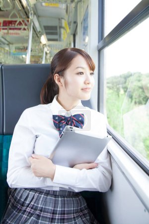 Foto de Asiática joven estudiante sentado en autobús - Imagen libre de derechos