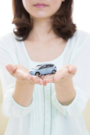 Photo for Woman with car model  in hands - Royalty Free Image