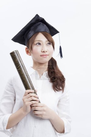 Photo for Asian female graduate with a diploma on white background - Royalty Free Image