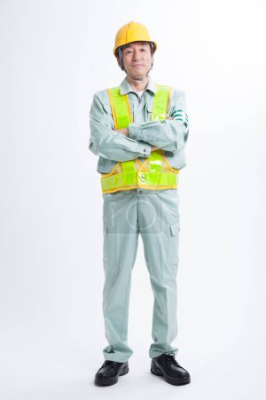 Photo for Asian construction worker with arms folded, studio shot - Royalty Free Image