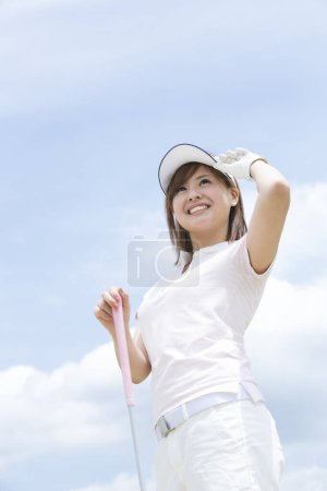Téléchargez les photos : Femme jouant au golf sur le terrain de golf - en image libre de droit