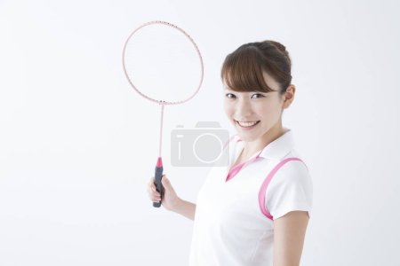 Photo for Smiling Japanese woman with badminton racket - Royalty Free Image