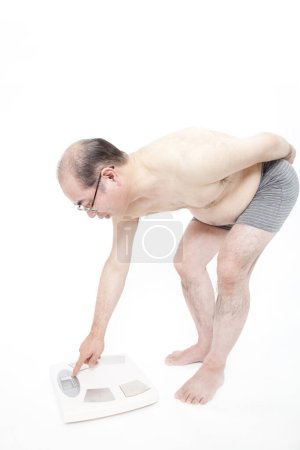 Photo for Japanese fat man in underwear with weight scales. Concept of losing weight - Royalty Free Image