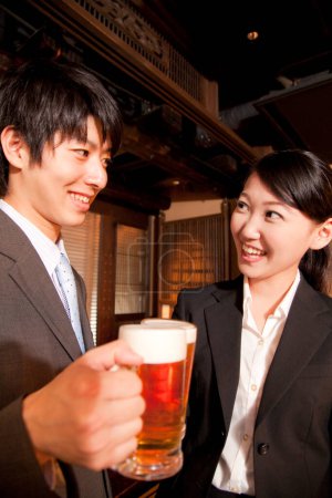 Photo for Japanese business people with beer at bar - Royalty Free Image