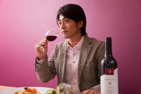 Photo for Asian man with  red wine in restaurant - Royalty Free Image