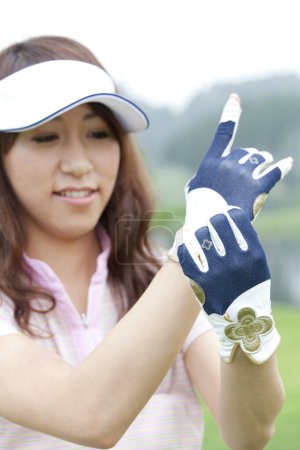 Photo for Asian young woman golf player in gloves - Royalty Free Image