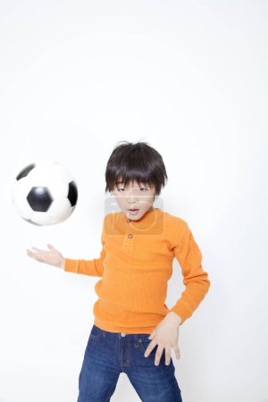 Photo for Portrait of young asian boy with soccer ball - Royalty Free Image