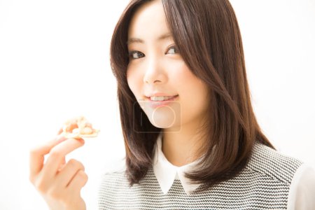 Photo for Beautiful Japanese woman holding cracker with topping - Royalty Free Image