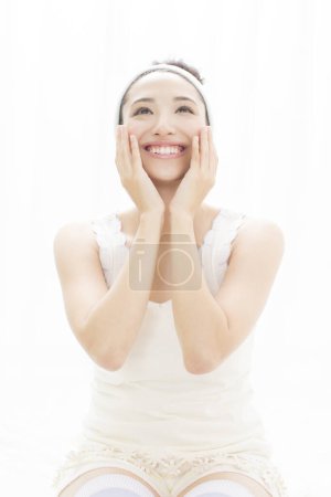 Photo for Japanese woman cleaning face, closeup portrait of young lady washing her face - Royalty Free Image