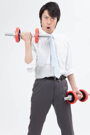 Foto de Retrato de adulto japonés hombre de negocios haciendo ejercicio en blanco fondo - Imagen libre de derechos