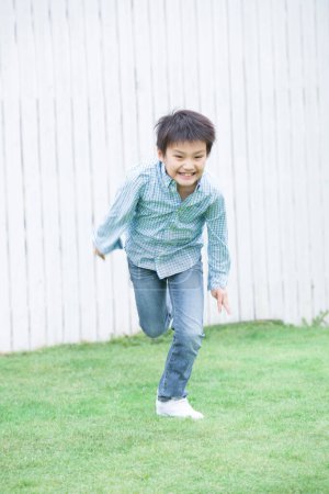 Photo for Asian boy playing in the park - Royalty Free Image