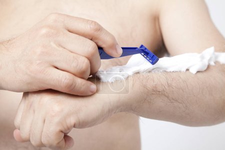 Photo for Young man shaving hand with razor, close up view - Royalty Free Image