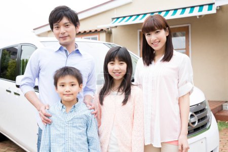 Photo for Portrait of happy Japanese family posing near house - Royalty Free Image