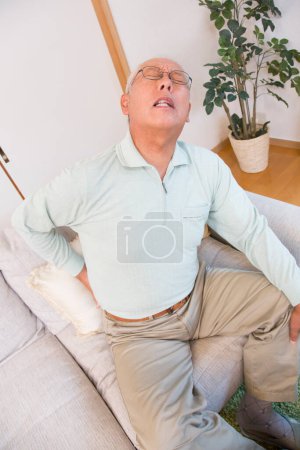 Photo for Senior asian businessman suffering from backache - Royalty Free Image