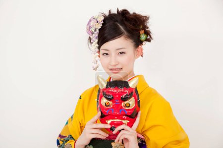 Foto de Hermosa joven mujer usando tradicional japonés kimono celebración máscara - Imagen libre de derechos
