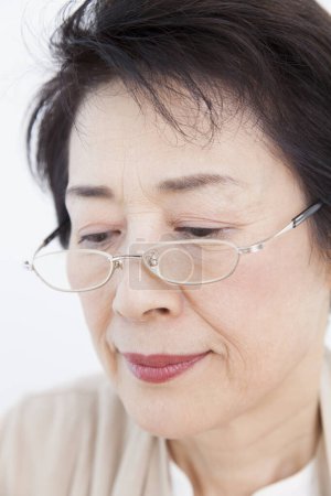 Photo for Senior asian woman in glasses, studio shot - Royalty Free Image