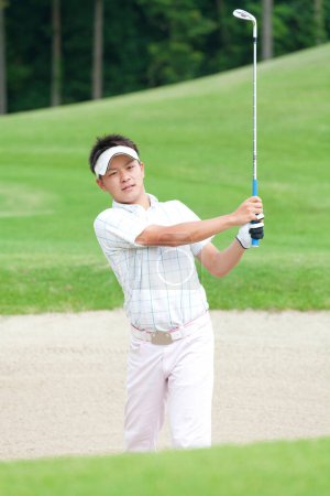 Photo for Young Japanese man playing golf at daytime - Royalty Free Image