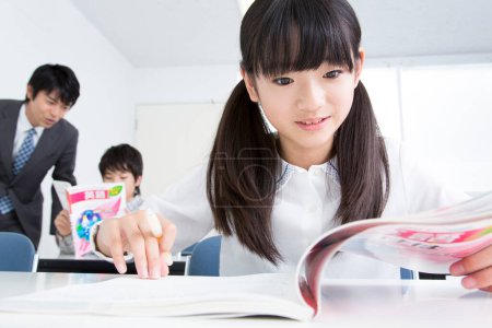 Photo for Portrait of Japanese girl and boy studying in school - Royalty Free Image
