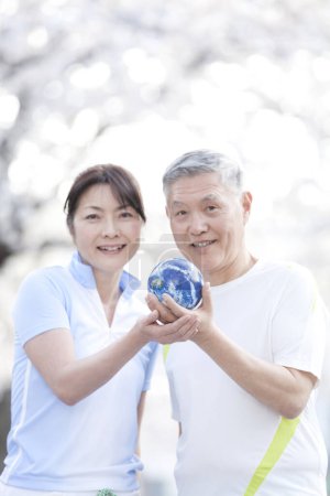 Téléchargez les photos : Mature asiatique couple holding globe - en image libre de droit