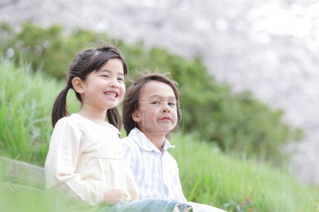 Photo for Close up cute asian boy and girl posing outdoors - Royalty Free Image