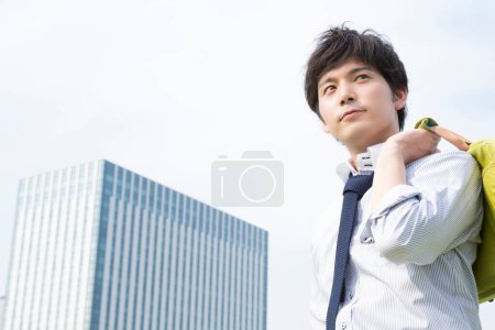 Photo for Asian young man with bag  on  city background - Royalty Free Image