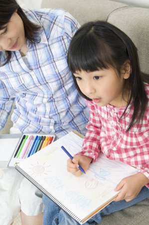 Photo for Portrait of smiling Japanese mother and daughter drawing - Royalty Free Image
