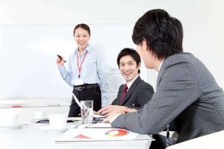 Photo for Group of young Japanese business team discussing project. teamwork concept - Royalty Free Image