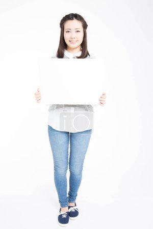 Photo for Studio portrait of beautiful Japanese woman holding blank white board - Royalty Free Image