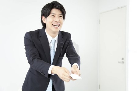 Photo for Asian businessman holding card  in office - Royalty Free Image