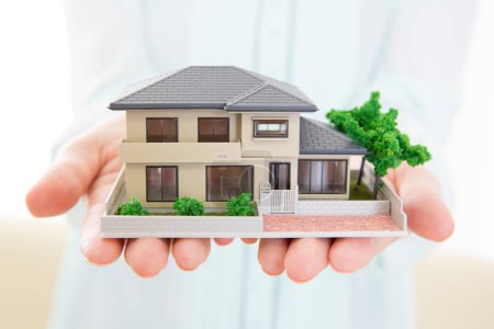 Photo for House with house  model in hands - Royalty Free Image