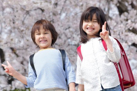 Photo for Cute Japanese girl and boy in spring park. concept of education - Royalty Free Image