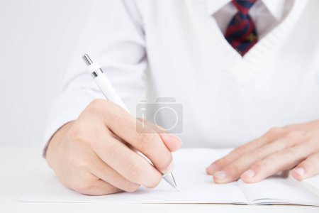 Photo for Young businessman writing in notebook - Royalty Free Image