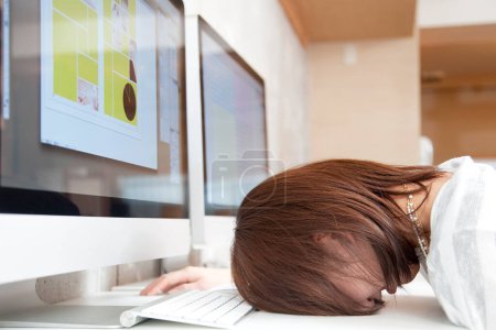 Photo for Tired woman sleeping in office - Royalty Free Image