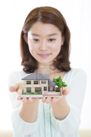 Photo for Asian woman with  house model - Royalty Free Image