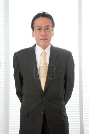 Photo for Portrait of a businessman standing in office - Royalty Free Image