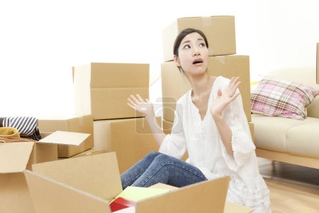 Photo for Young asian woman moving into new house - Royalty Free Image