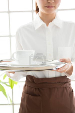 Photo for Waitress with tray of cup - Royalty Free Image