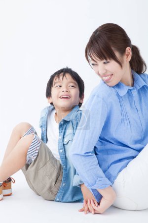 Photo for Portrait of young asian mother and her cute son posing in studio - Royalty Free Image