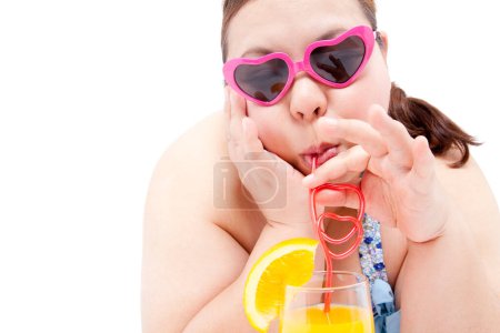 Photo for Girl in heart shaped sunglasses drinking cocktail - Royalty Free Image