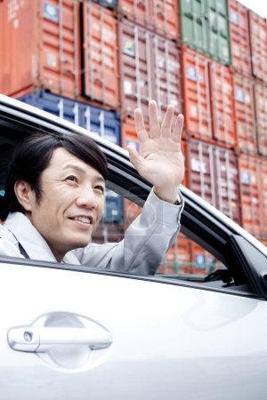Photo for Asian man in  car hand waving - Royalty Free Image