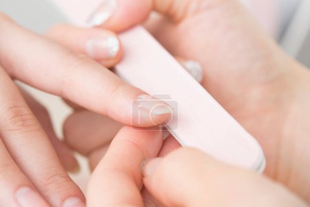 Photo for Close up of a woman doing manicure in beauty salon. nail treatment concept. - Royalty Free Image