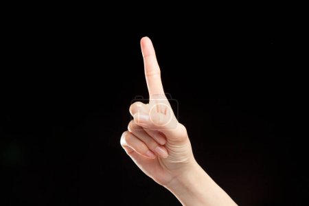 Photo for Close up of woman hand showing gesture against black background - Royalty Free Image