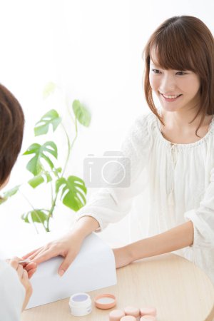Photo for Close up of a woman doing manicure in beauty salon. nail treatment concept. - Royalty Free Image