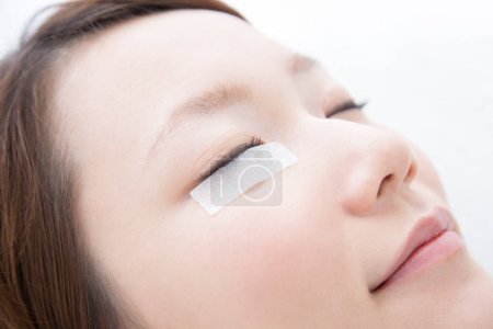 Photo for Woman making eyelash extension procedure, closeup - Royalty Free Image
