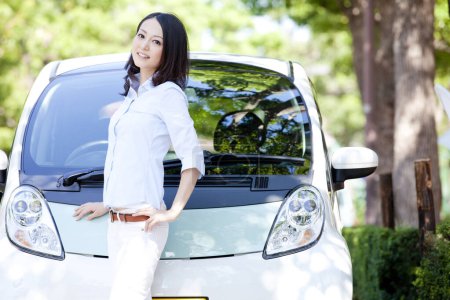 Photo for Young woman standing near her car - Royalty Free Image